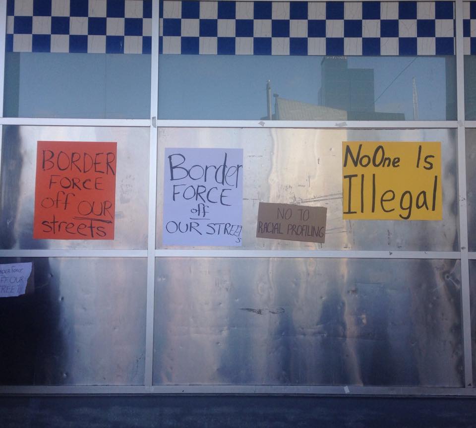 Protest signs on Flinders St Police Station. Photo- Katie Coulthard