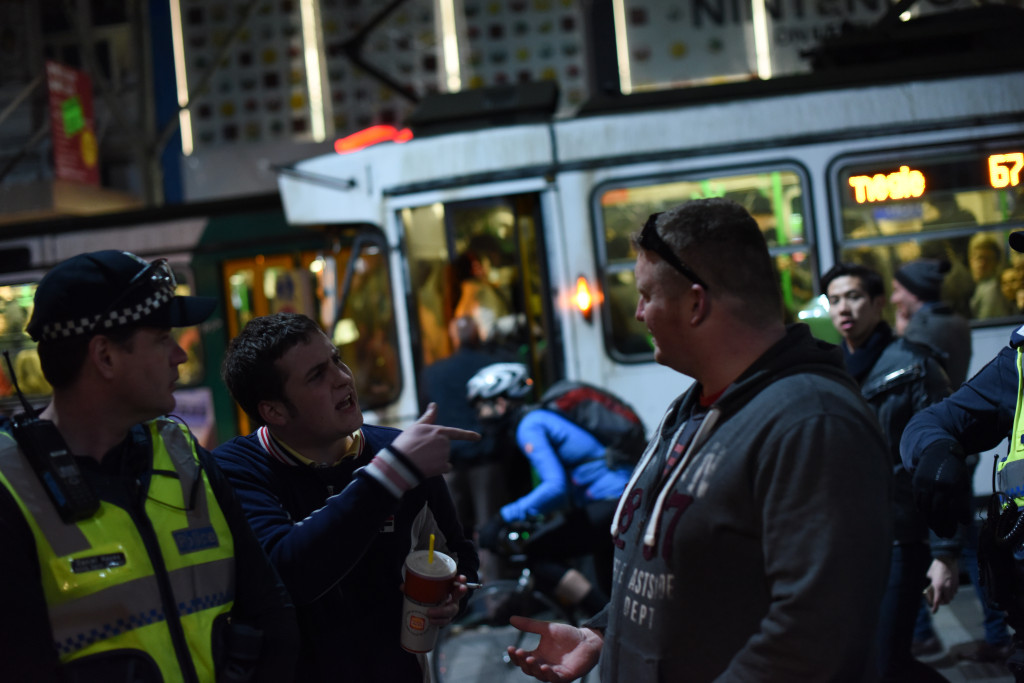 A member of the crowd [left] confronts the suspected UPF member [right]. Photo - Finbar O'Mallon